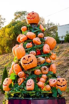 Tower of Decorative Jack-O’-Lantern Pumpkins in Outdoor Halloween Display Stock Photos