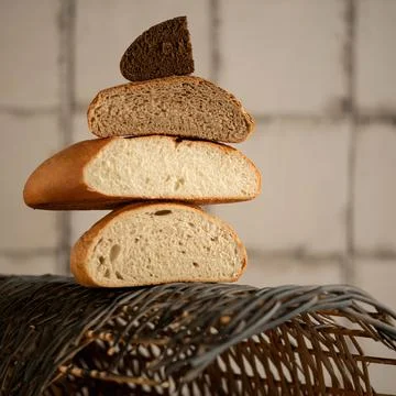 Tower of different types of bread halves. White, dark, wheat and rye mixed bread Stock Photos