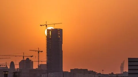 A tower in Doha timelapse, Qatar, under construction, silhouetted against t.. Stock Photos