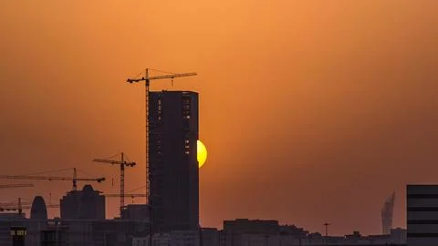 A tower in Doha timelapse, Qatar, under construction, silhouetted against t.. Stock Photos