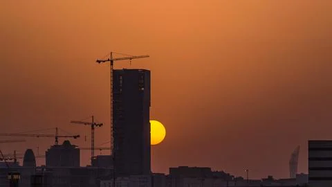 A tower in Doha timelapse, Qatar, under construction, silhouetted against the Stock Photos