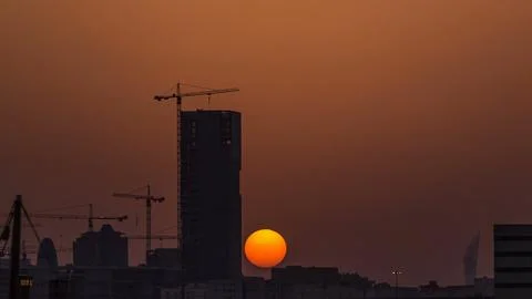 A tower in Doha timelapse, Qatar, under construction, silhouetted against t.. Stock Photos