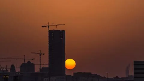 A tower in Doha timelapse, Qatar, under construction, silhouetted against t.. Stock Photos