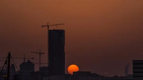 A tower in Doha timelapse, Qatar, under construction, silhouetted against t.. Stock Photos