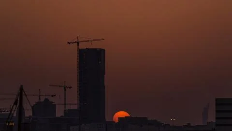 A tower in Doha timelapse, Qatar, under construction, silhouetted against t.. Stock Photos
