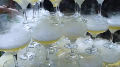 Tower of drinks, a slide of champagne with dry ice and smoke at a party. Glasses Video stock 262177113