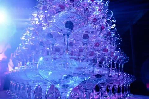 A tower of empty martini glasses with a cherry is on the table. Party at the Stock Photos