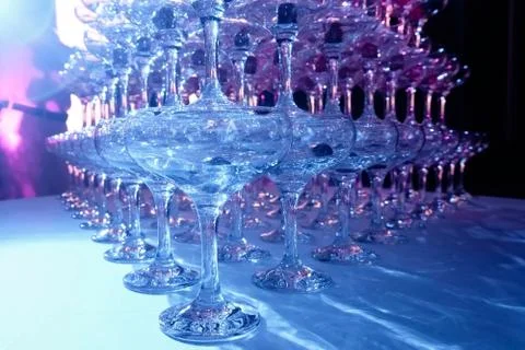 A tower of empty martini glasses with a cherry is on the table. Party at the Stock Photos