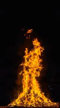 Tower of flames on a bonfire in vertical Stock Photos