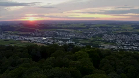 Tower in the Forest Aerial View Overlooking a Small Town at Sunset 库存影片 331169283