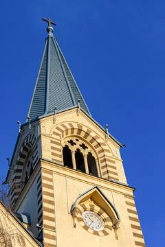 Tower of gothic architecture with clock on blue sky background Stock Photos