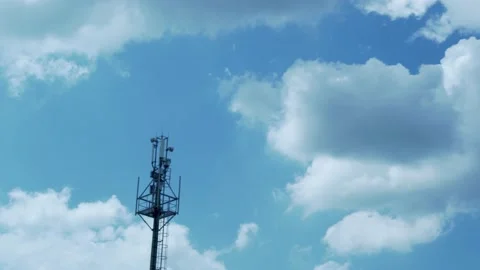 A Tower of GSM Mobile Operators and A Beautiful Time Lapse of White Puffy Flying Stock Footage 154685039