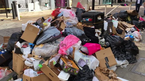 Tower Hamlets refuse collection strike. Overflowing mountain of rubbish waste. Video stock 251560384