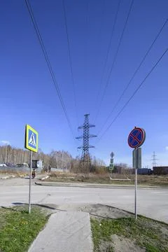The tower of a high-voltage power line on the industrial outskirts of city Stock Photos