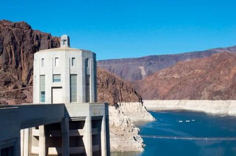 Tower in Hoover Dam surrounded by sharp rocks Stock Photos