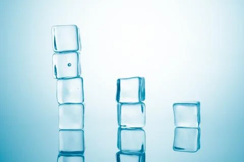 Tower from ice cubes on blue background Stock Photos
