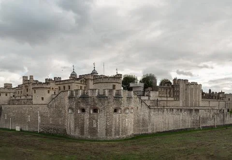 The Tower of London stands as a formidable stone sentinel beneath a heavy, .. Stock Photos