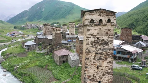Tower of Lower Chazhash Castle and Ushguli village at the foot of Mt. Shkhara Stock Footage 128384225