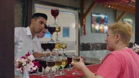 Tower made of glasses with champagne on table. View of delicious alcohol free Video stock 279057099