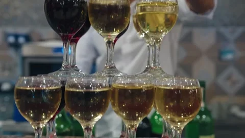Tower made of glasses with champagne on table. View of delicious alcohol free Video stock 279057154
