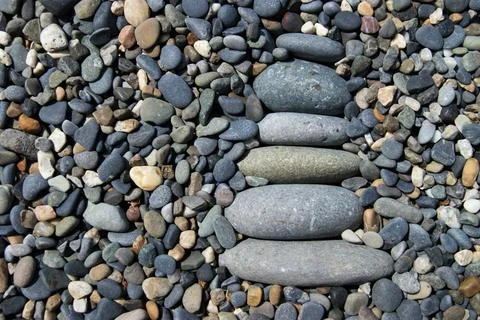 The tower is made of various pebbles. Zen tower on a rocky beach. Stock Photos