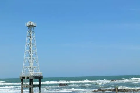 Tower in the middle of the beach and waves Stock Photos