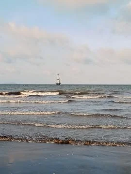 Tower in the middle of the beach with clouds Stock Photos