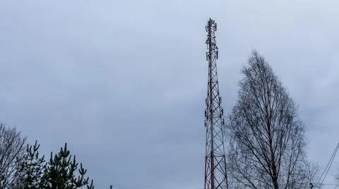 Tower with mobile operator antennas on the dramatic sky background. Tower hos Stock Photos