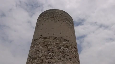 Tower Mora old stone cloudy overcast sky wind medieval historical low angle Stock Footage 328831530