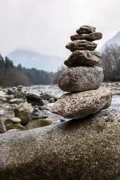 Tower of pebbles on the river Stock Photos