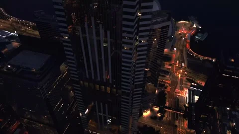 Tower pinnacle and illuminated spire piercing evening sky filmed by drone in Vidéo 343900739