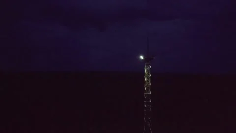 Tower with a searchlight on the background of the night sky Video stock 137257206