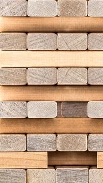 Tower stack made of wooden block bricks from a tumbling jenga game on a str.. Stock Photos