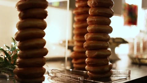 Tower Stack of Sweet Delicious Glazed Ring Donuts at a Wedding Reception Stock Footage 166282454