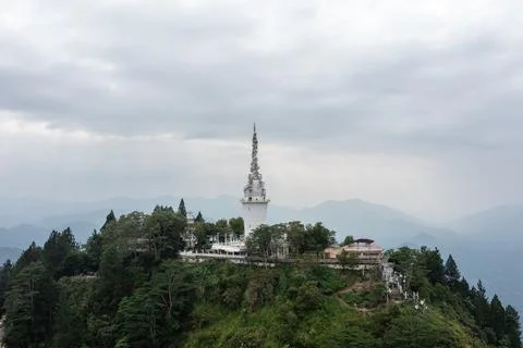 Tower standing on a green mountain peak in Sri Lanka under a dramatic overcast Stock Photos