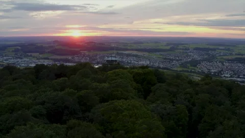 Tower Stands Above a Dense Forest Canopy During a Scenic Golden Sunset Vidéo 331169345