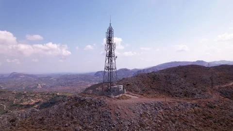 Tower stands tall on a mountain ridge with expansive views of the valley below Video stock 309549329