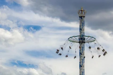 Tower Swing Ride Against a Dramatic Cloudy Sky Stock Photos