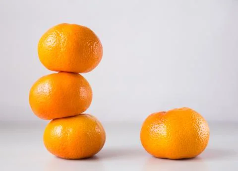 Tower of three mandarines on white background Stock Photos