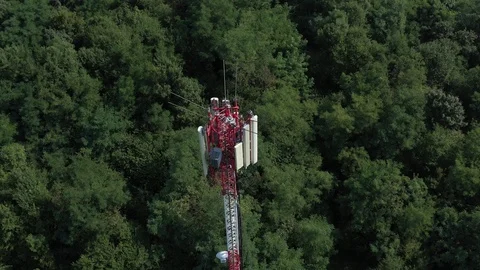 Tower of wireless communication antenna transmitter and repeater 4K aerial Stock Footage 115649600