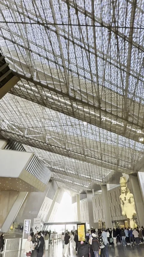 A towering ancient Egyptian statue stands majestically inside the Grand Egypt Stock Footage 335030242