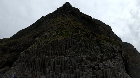Towering basalt columns and jagged peaks at Reynisfjara beach, Iceland Stock Footage 334464165