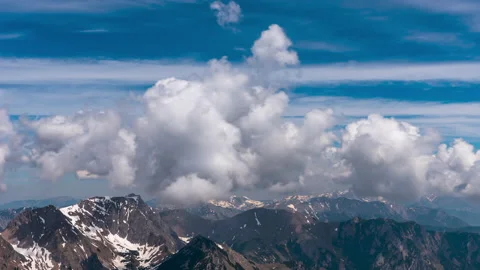 Towering clouds over a mountain landscape timelapse Stock Footage 155567061