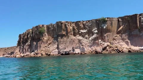 Towering Coastal Cliffs with Aqua Waters Stock Footage 293742879
