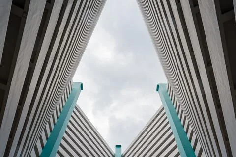 Towering concrete structures frame a cloudy sky Stock Photos