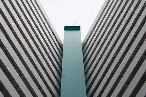 Towering concrete structures frame a narrow sky Stock Photos