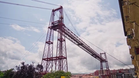 A towering crane stands adjacent to a high-rise building Vídeos de archivo 260545884