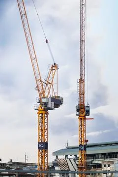 A towering crane stands as the sentinel of progress. Its massive steel fram.. Stock Photos