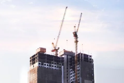 A towering crane stands as the sentinel of progress. Its massive steel fram.. Stock Photos