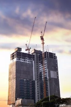 A towering crane stands as the sentinel of progress. Its massive steel fram.. Stock Photos